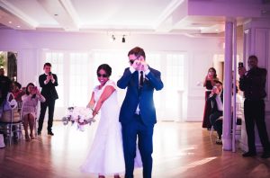 bride and groom bumping buts on the dance floor