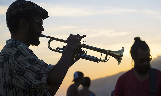 people playing the trumpet and guitar