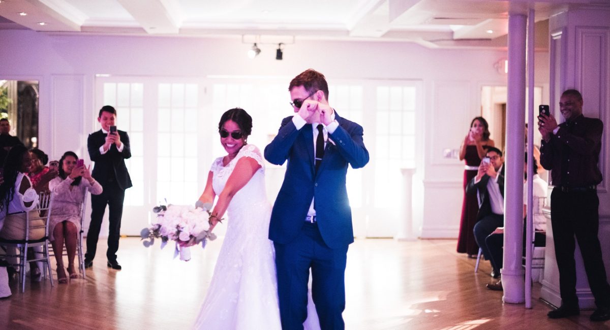 bride and groom bumping buts on the dance floor